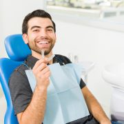 Close up of a happy man using invisible orthodontics