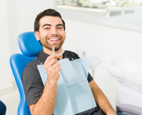 Close up of a happy man using invisible orthodontics